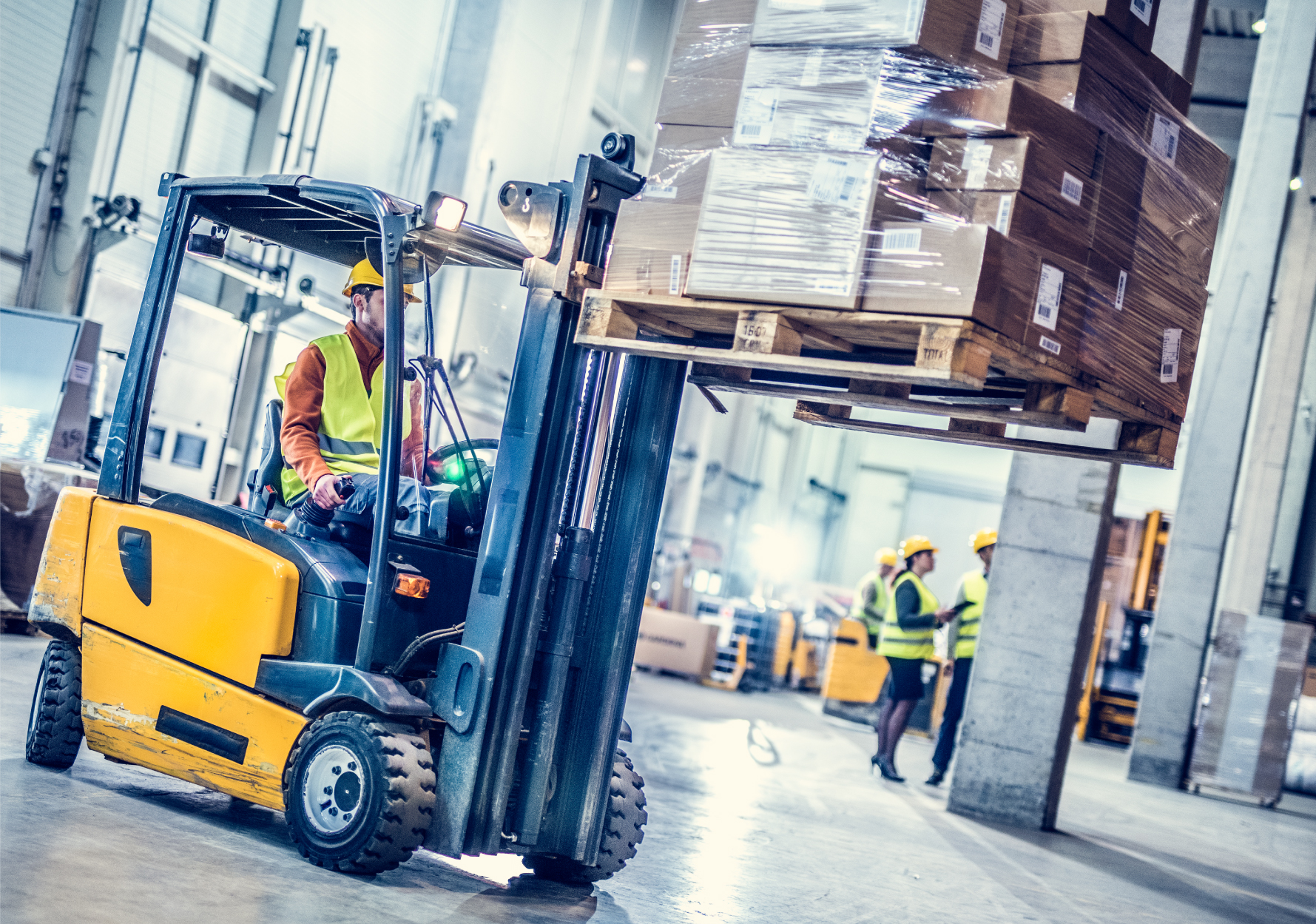 Forklift lifting pallet of boxes